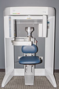 White panoramic/CBCT dental imaging unit with blue patient chair, control panel, and open side access